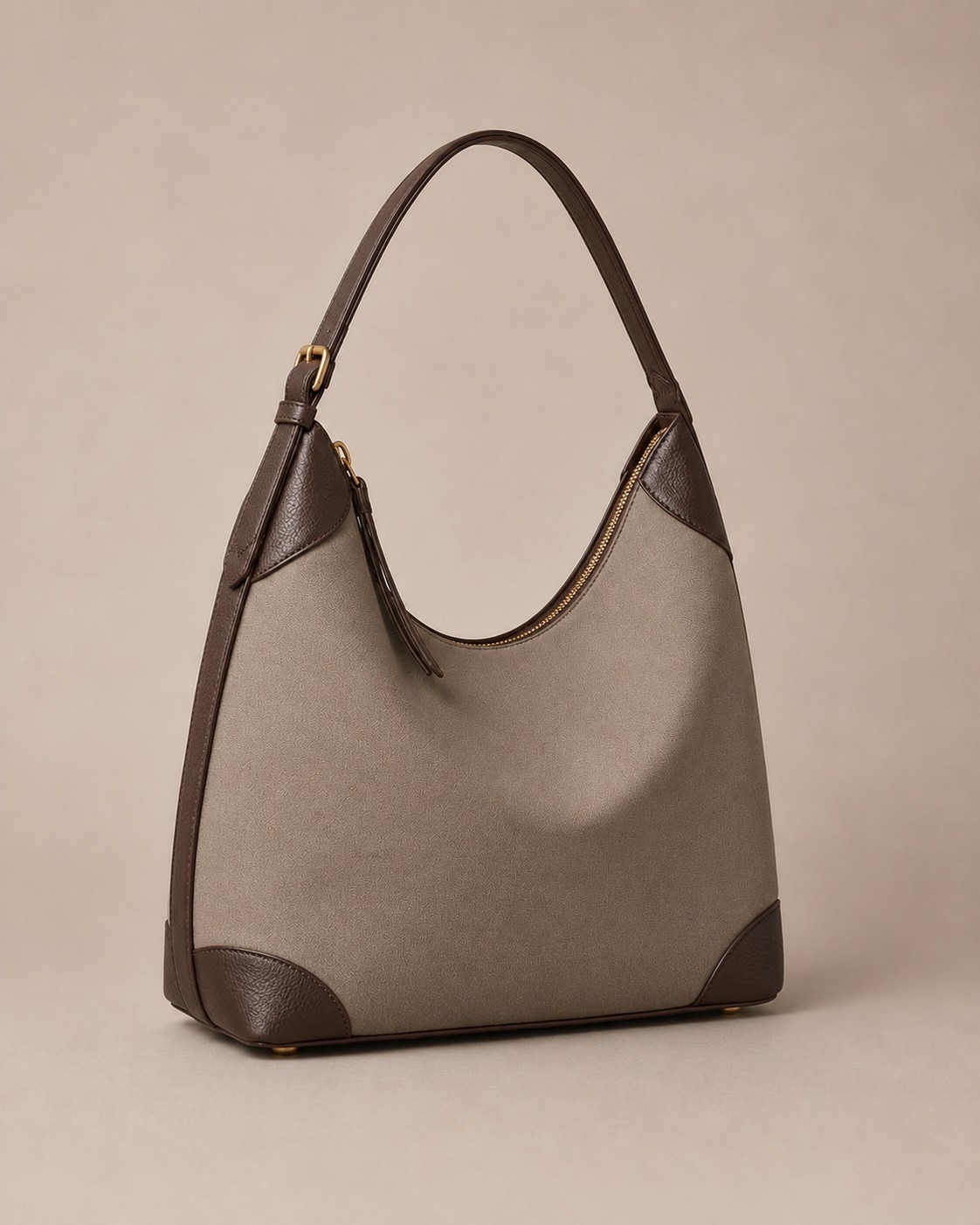 The Aria shoulder bag, three-quarter view showing the brass turn-lock and adjustable strap.